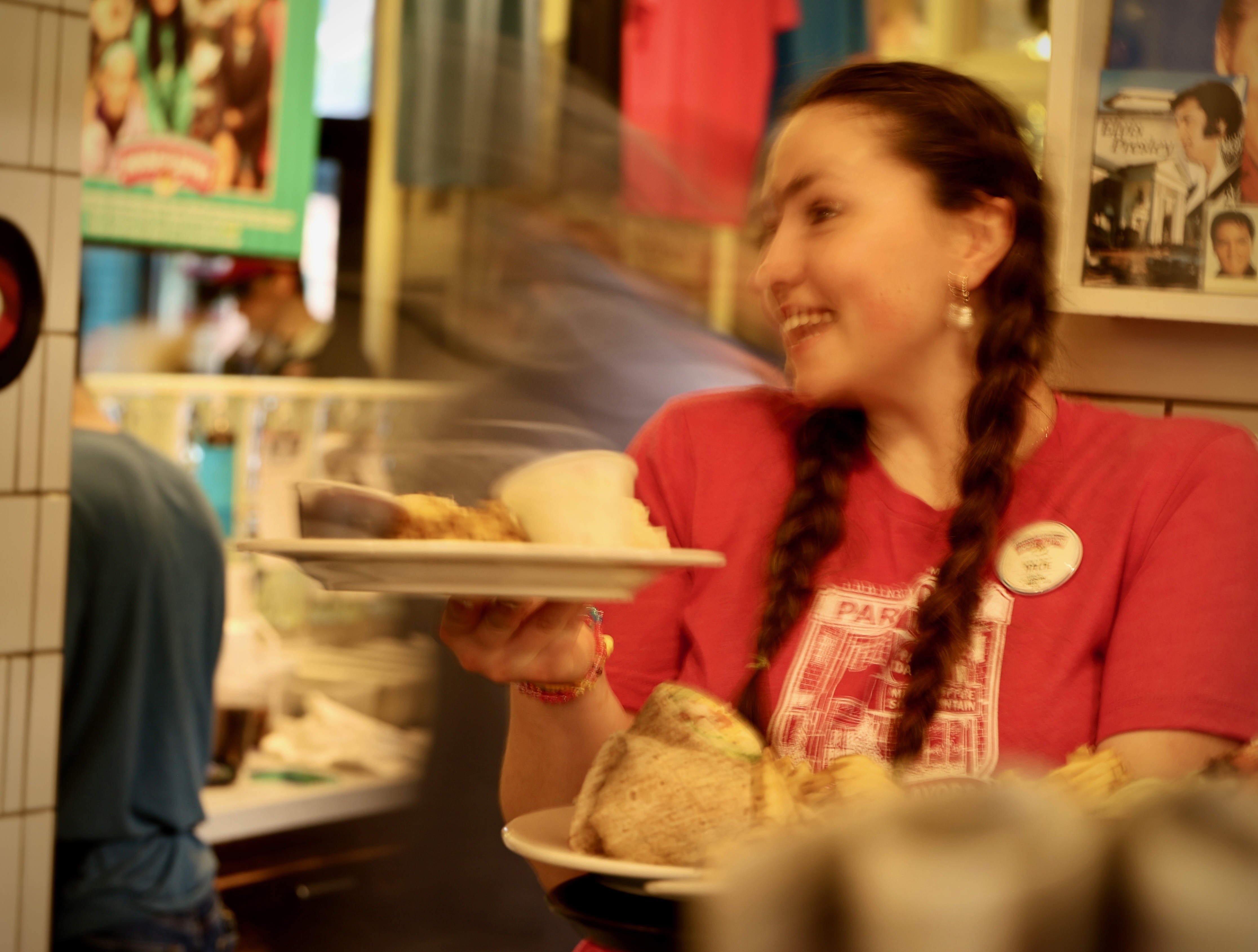 House of Flavors employee serving meals to customers in Ludington.